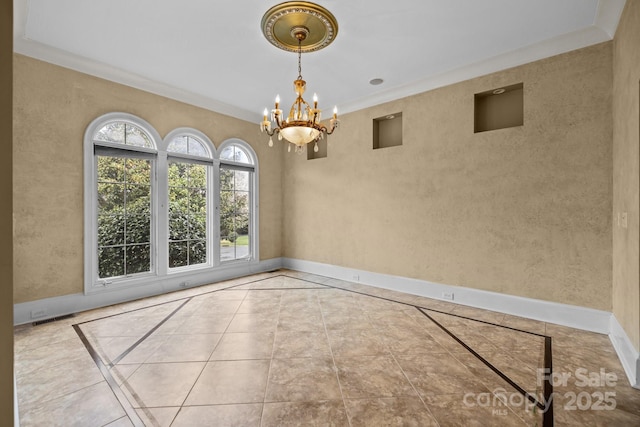 unfurnished dining area featuring crown molding, visible vents, a notable chandelier, and baseboards