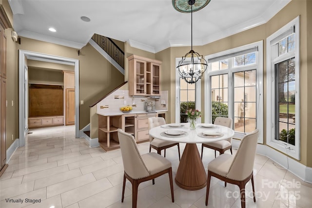 dining area with baseboards, crown molding, an inviting chandelier, and light tile patterned floors