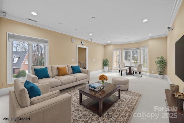 living area with a healthy amount of sunlight, recessed lighting, visible vents, and ornamental molding