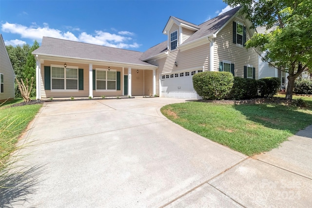 view of front of home with a front lawn and a garage