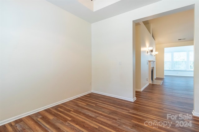 spare room with dark hardwood / wood-style floors