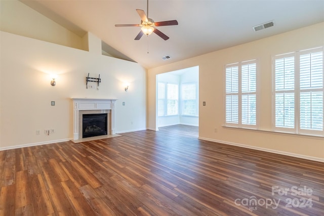 unfurnished living room featuring ceiling fan, dark hardwood / wood-style floors, and high vaulted ceiling