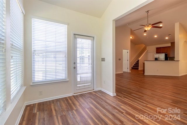 entryway with ceiling fan, lofted ceiling, and dark wood-type flooring