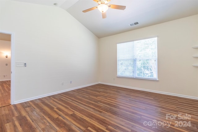 empty room featuring ceiling fan, dark hardwood / wood-style floors, and vaulted ceiling