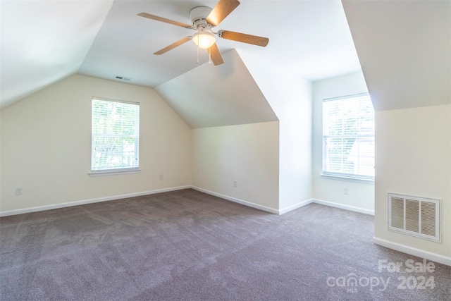 bonus room with carpet floors, lofted ceiling, plenty of natural light, and ceiling fan