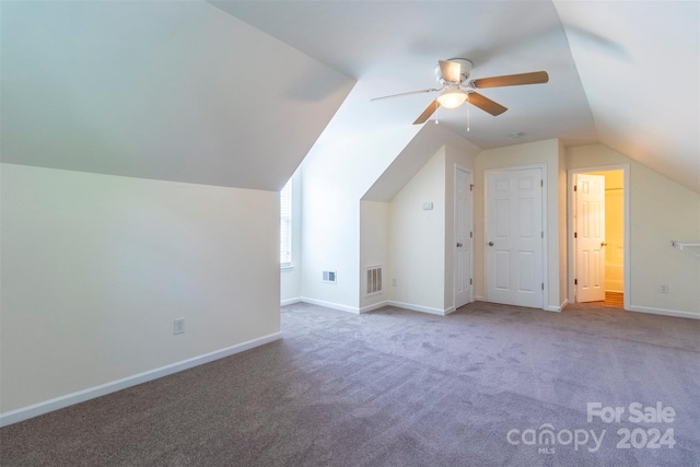 additional living space with ceiling fan, vaulted ceiling, and carpet flooring