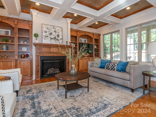 living room featuring crown molding, coffered ceiling, and wood-type flooring