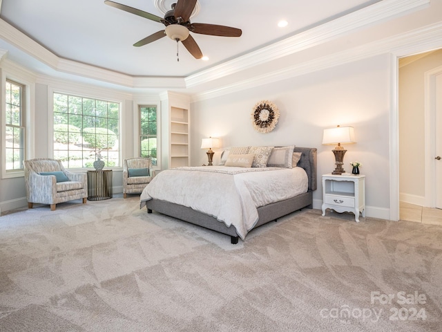 carpeted bedroom with ornamental molding, a raised ceiling, and ceiling fan