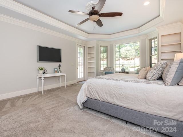 carpeted bedroom with crown molding, a raised ceiling, and ceiling fan