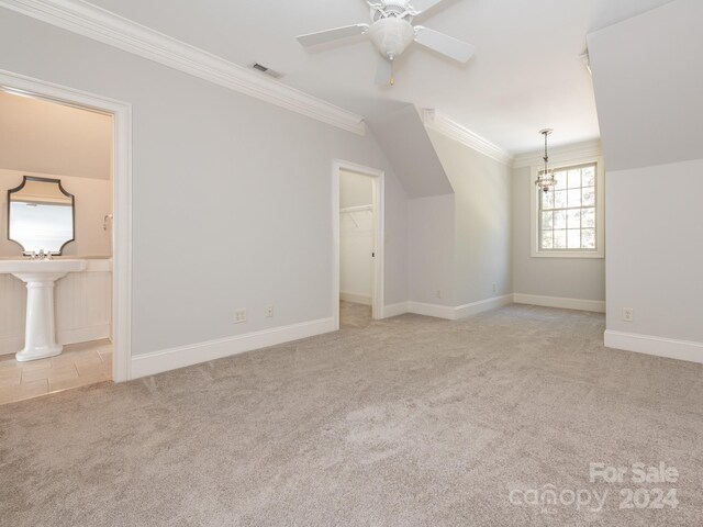 additional living space featuring light colored carpet and ceiling fan with notable chandelier