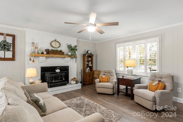 living room with crown molding, a wood stove, dark hardwood / wood-style floors, and ceiling fan