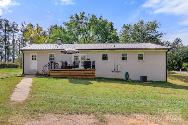 back of house with a yard and a deck