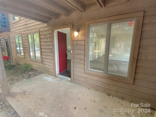 entrance to property featuring a patio