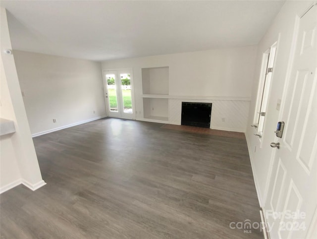 unfurnished living room featuring dark hardwood / wood-style floors