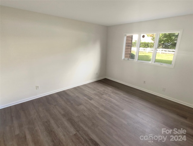 empty room with dark hardwood / wood-style floors