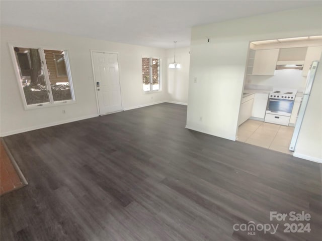 unfurnished living room featuring wood-type flooring