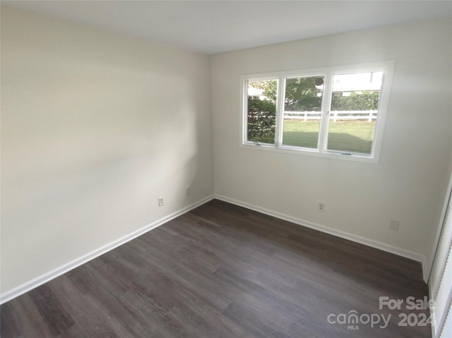 spare room featuring dark wood-type flooring