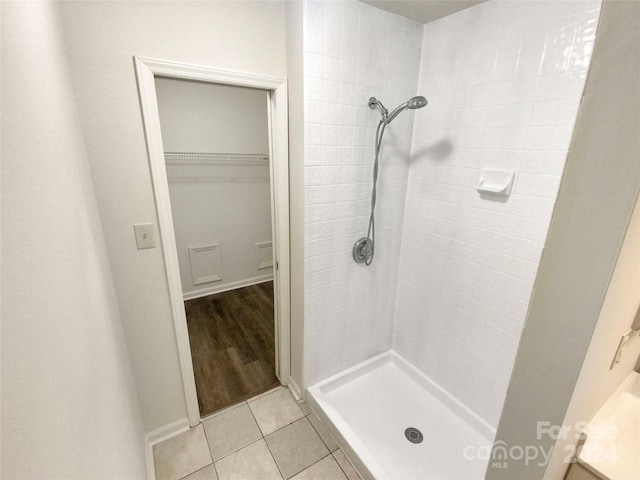 bathroom featuring vanity, tiled shower, and hardwood / wood-style flooring