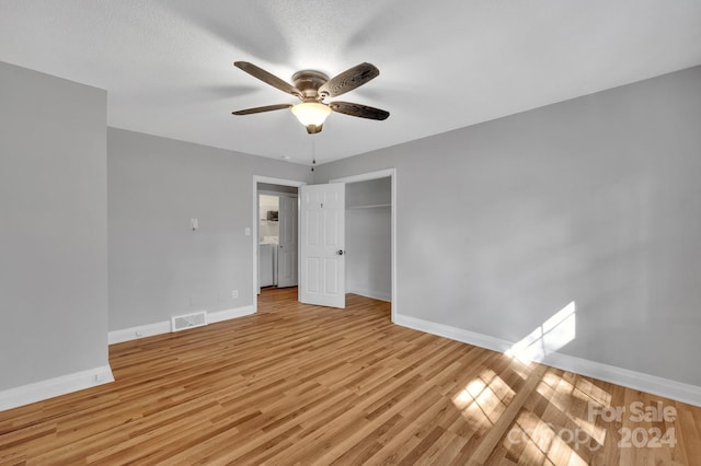 unfurnished bedroom with a closet, a textured ceiling, light wood-type flooring, and ceiling fan