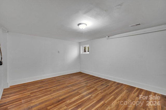 unfurnished room with hardwood / wood-style floors