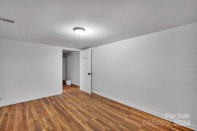 unfurnished room featuring hardwood / wood-style flooring