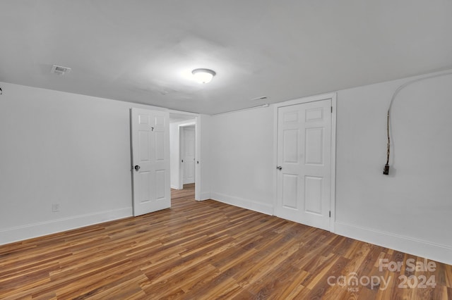 unfurnished room with hardwood / wood-style flooring