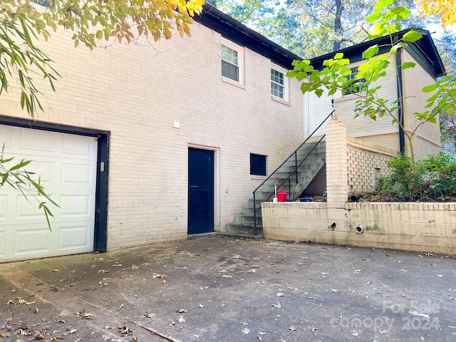 back of property featuring a garage