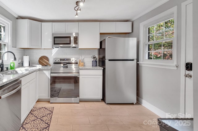 508 Deese St, Monroe, NC 28112 - kitchen with stainless steel appliances, tasteful backsplash, white cabinetry, light stone counters, and crown molding