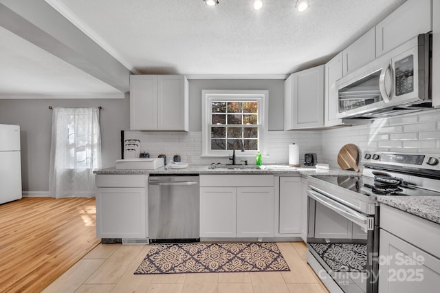 508 Deese St, Monroe, NC 28112 - kitchen with stainless steel appliances, crown molding, decorative backsplash, light stone countertops, and a textured ceiling