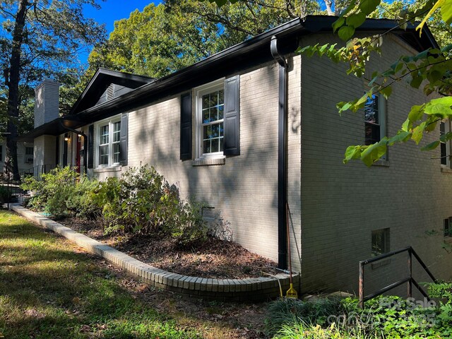 508 Deese St, Monroe, NC 28112 - view of side of property with a chimney and brick siding