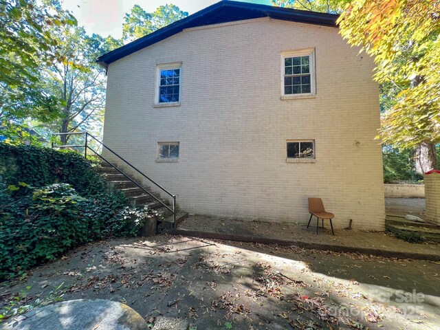 508 Deese St, Monroe, NC 28112 - view of property exterior with brick siding, stairs, and a patio