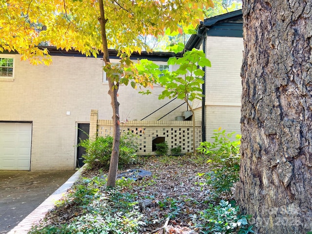 508 Deese St, Monroe, NC 28112 - view of home's exterior featuring brick siding, a garage, and driveway