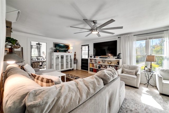 living room featuring light hardwood / wood-style floors and ceiling fan