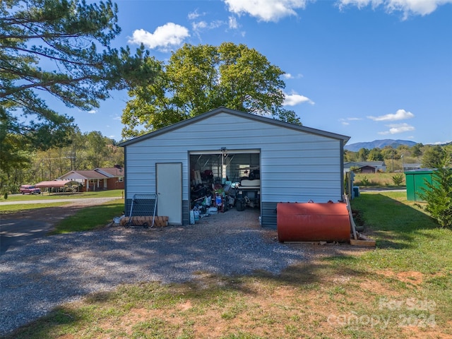 view of outbuilding featuring a yard and a mountain view