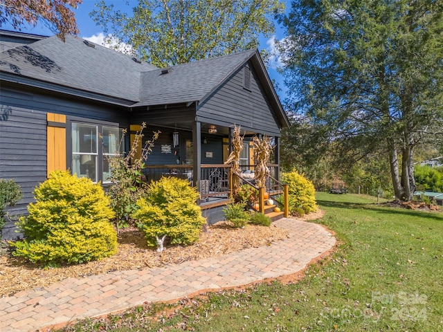 view of front of property with a front yard and a porch