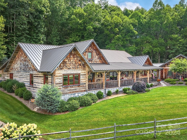 log home featuring a front yard and a porch