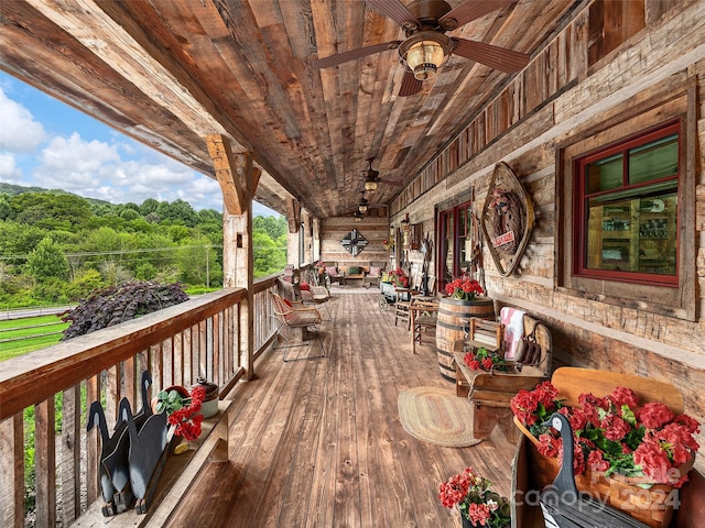 wooden deck featuring ceiling fan and a porch