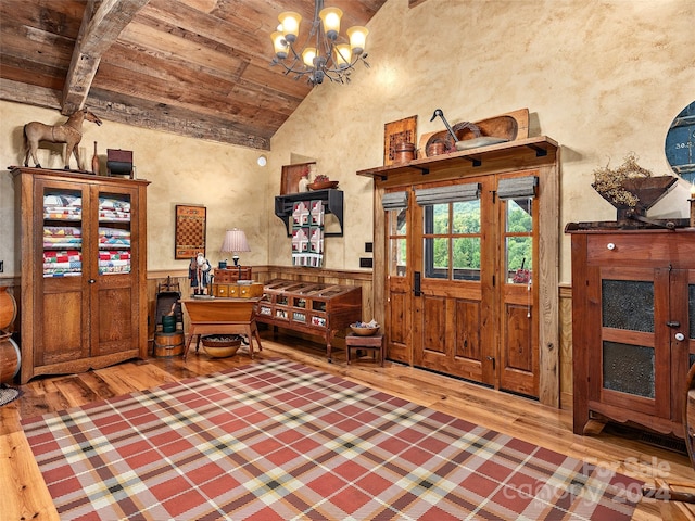 foyer entrance featuring vaulted ceiling with beams, wood ceiling, hardwood / wood-style floors, and a chandelier