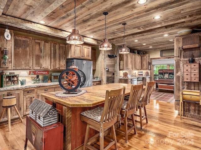 kitchen with light hardwood / wood-style floors, stainless steel refrigerator, wood ceiling, and hanging light fixtures