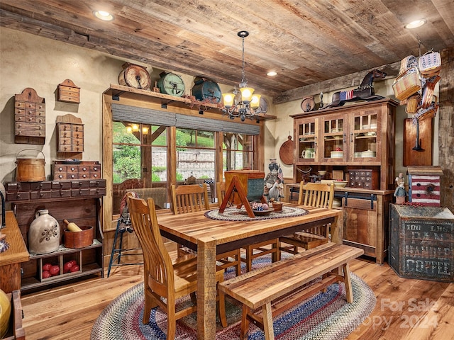 dining space featuring light hardwood / wood-style flooring, a chandelier, and wood ceiling