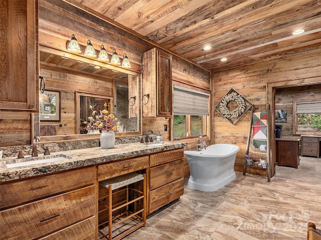 bathroom featuring wood walls, vanity, wooden ceiling, and a bathing tub