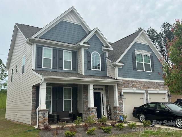 craftsman-style home featuring a garage and covered porch