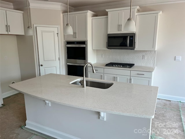 kitchen featuring light stone counters, stainless steel appliances, white cabinets, sink, and decorative light fixtures