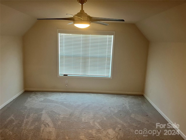 additional living space with carpet floors, lofted ceiling, and ceiling fan