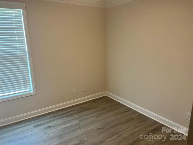 spare room with dark hardwood / wood-style floors