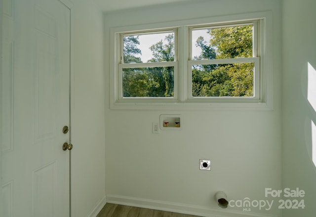 washroom with hookup for an electric dryer, hardwood / wood-style floors, and hookup for a washing machine