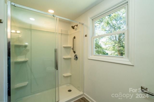 bathroom featuring a shower with shower door