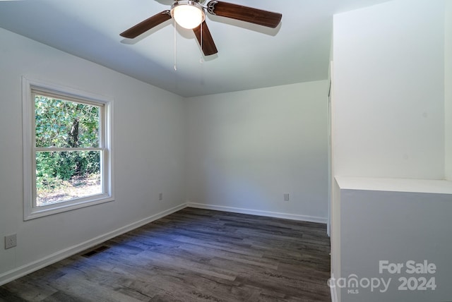 unfurnished room with dark hardwood / wood-style floors and ceiling fan