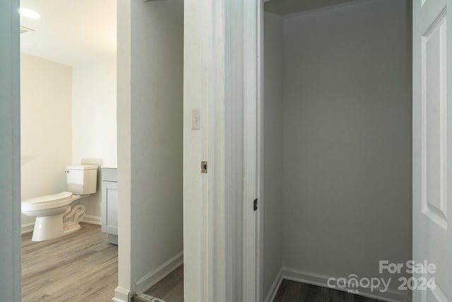 bathroom featuring hardwood / wood-style floors and toilet