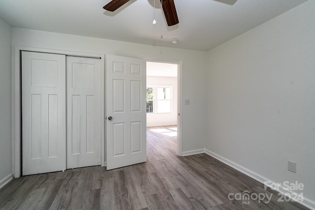 unfurnished bedroom featuring light hardwood / wood-style floors, a closet, and ceiling fan